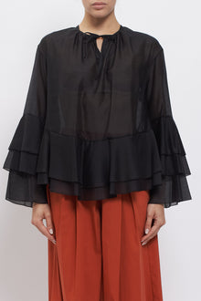 Blusa con maniche volant