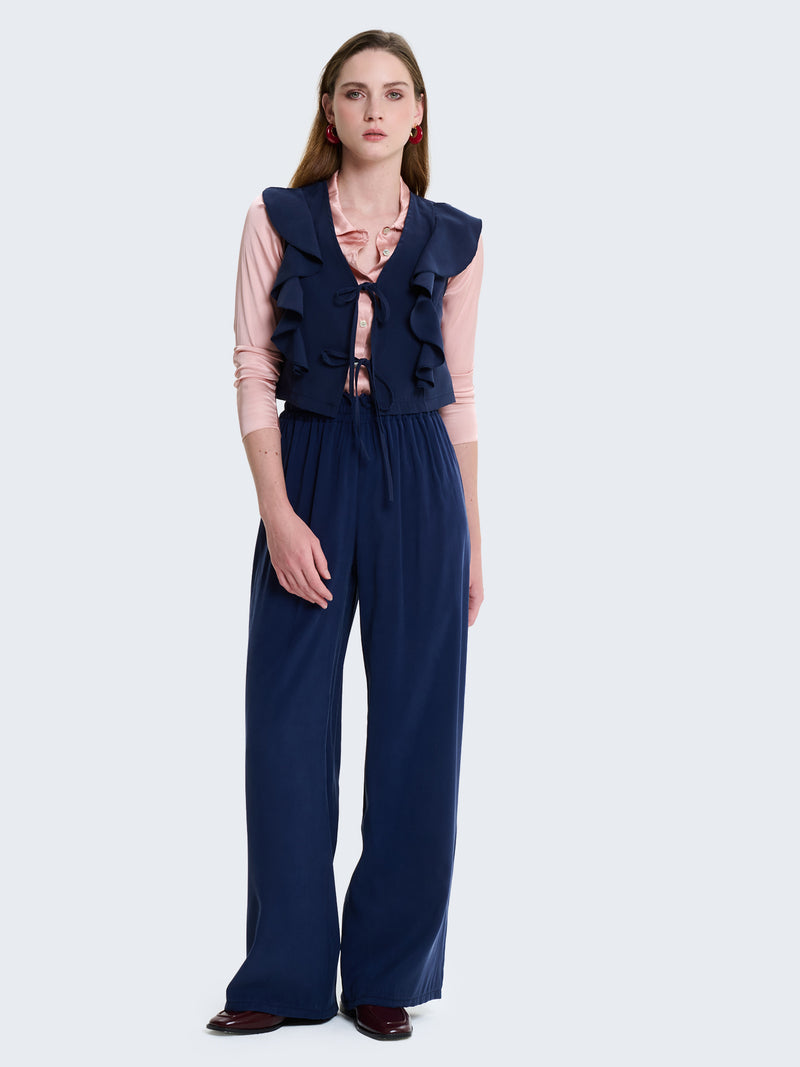 Gilet con laccetti e volant in cupro