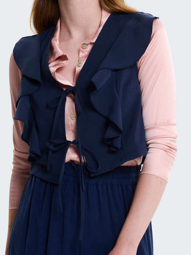 Gilet con laccetti e volant in cupro