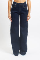 Jeans wide leg con borchie