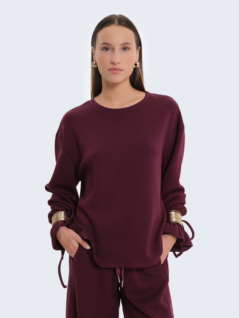 Felpa con bracciali
