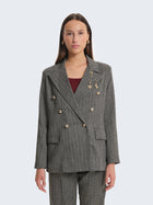 Blazer con tessuto spigato e charms